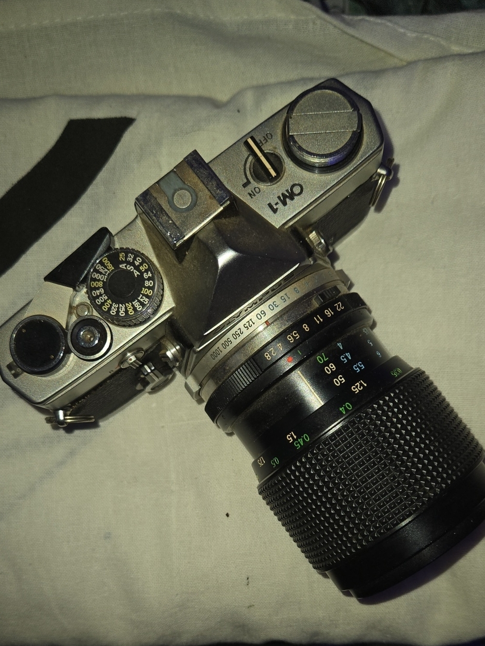 Olympus OM-1 Silver and Black Film SLR with Black Zoom Lens